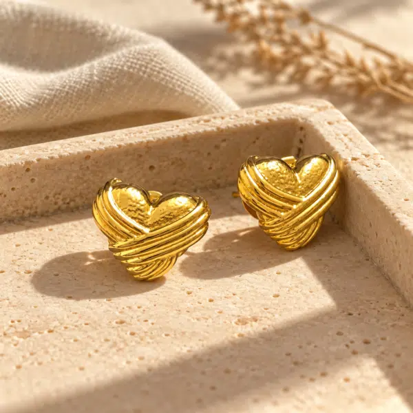 Crossed Ribbon Heart Studs styled on a display