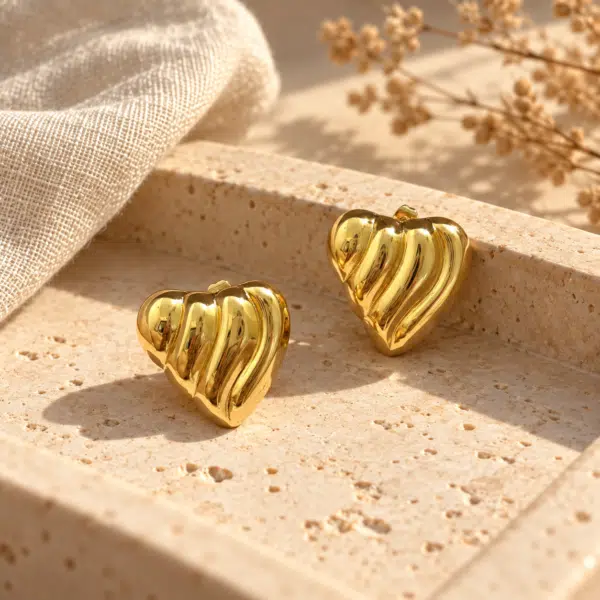 Ribbed Puffed Heart Studs styled on a display