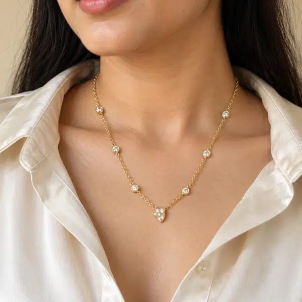 Woman wearing gold plated delicate heart necklace