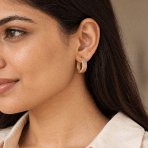 Model wearing gold pavé hoop earrings