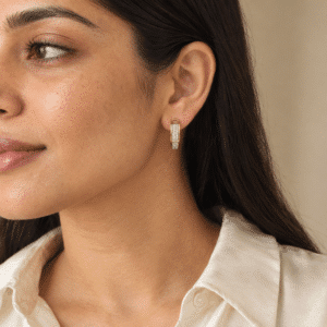 A woman wearing elegant gold plated huggie hoops