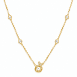 Close up of the Aurelia Pearl Body Necklace featuring a central pearl and diamond-encrusted cross pendant