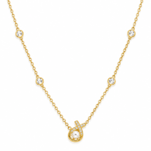 Close up of the Aurelia Pearl Body Necklace featuring a central pearl and diamond-encrusted cross pendant