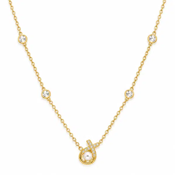 aurelia pearl body necklace feat Close up of the Aurelia Pearl Body Necklace featuring a central pearl and diamond-encrusted cross pendant