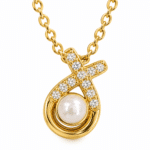 Detailed macro view of the elegant pearl and crystal pendant on the Aurelia Pearl Body Necklace