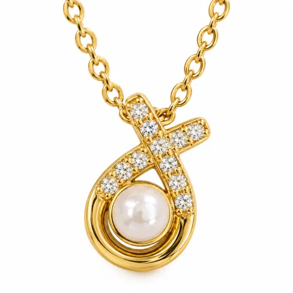 Detailed macro view of the elegant pearl and crystal pendant on the Aurelia Pearl Body Necklace