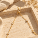 Close up of the Aurelia Pearl Body Necklace featuring a central pearl and diamond-encrusted cross pendant