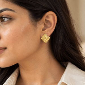 Model wearing gold Textured Gold Studs earring with a cream shirt