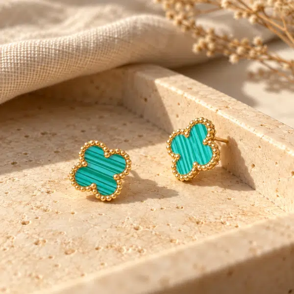 Azure Clover Gold Earrings styled on a display