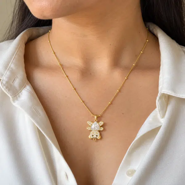 Model wearing a whimsical Bear Cub Golden Necklace