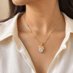 A woman wearing a delicate Bow Solitaire Golden Necklace on a white shirt
