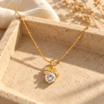 Bow Solitaire Golden Necklace showing a sparkling central stone with gold ribbon detail