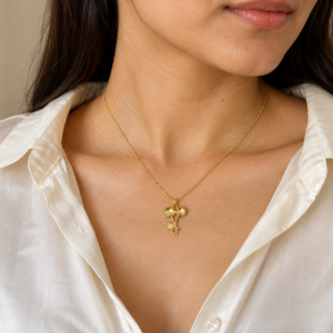 Model wearing gold plated cherry necklace with white blouse
