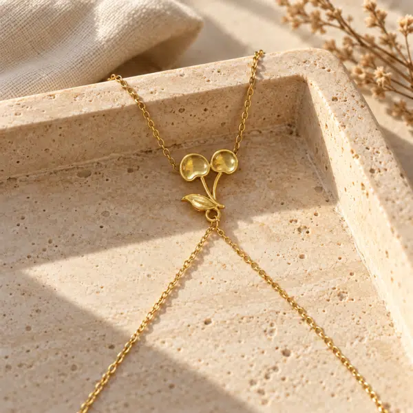 Close-up of gold plated cherry pendant necklace
