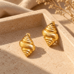 Conch Shell Gold Earrings styled on a display