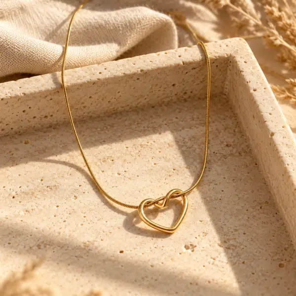 Elowyn Gold Heart Necklace styled on a display