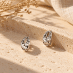 Filigree Oval Silver-Tone Earrings styled on a display