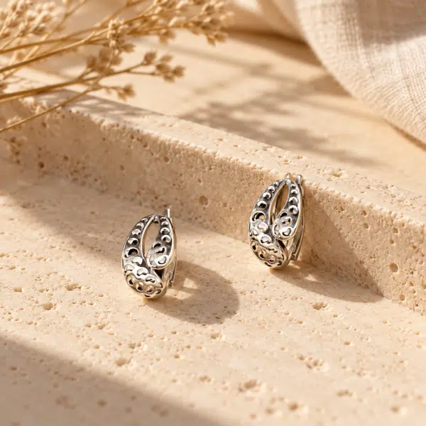 Filigree Oval Silver-Tone Earrings styled on a display