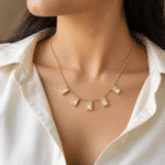 Elegant model wearing a gold baguette stone necklace with white shirt