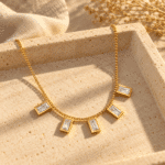 Lumina gold plated baguette stone necklace isolated on white