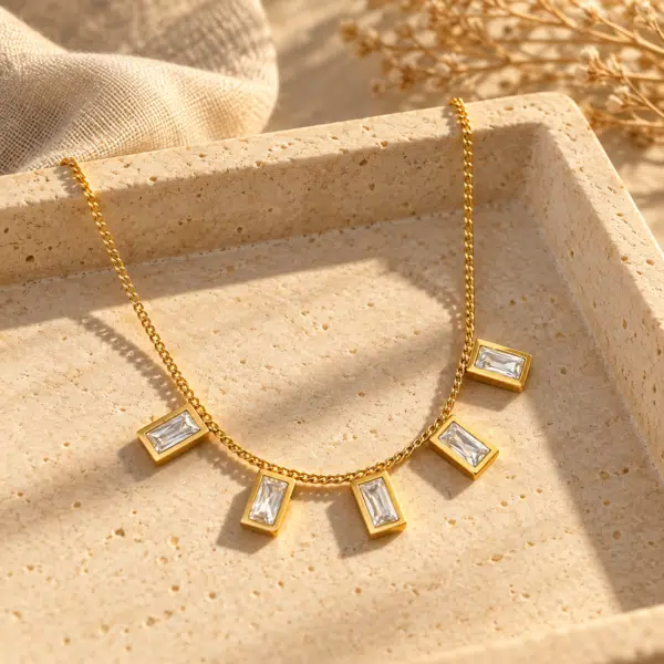 Lumina gold plated baguette stone necklace isolated on white