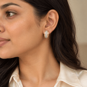 Woman wearing delicate gold Lumina Crystal Hoop Earrings