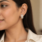 Wide Pavé Gold-Tone Hoop Earrings worn by a model