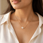 Woman wearing a gold plated necklace with pearl pendant