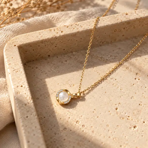 Gold plated necklace with pearl pendant on white background