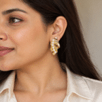 Model wearing elegant gold pearl statement earrings