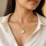 Woman wearing gold plated necklace with shell pendant