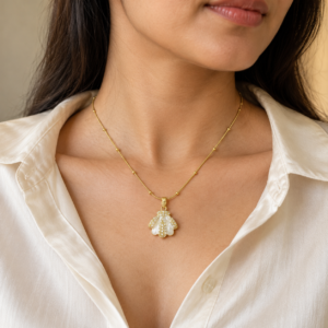 Woman wearing gold plated necklace with shell pendant