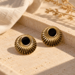 NoireSun Gold Studs styled on a display