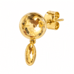 Close-up profile of gold stud drop earring