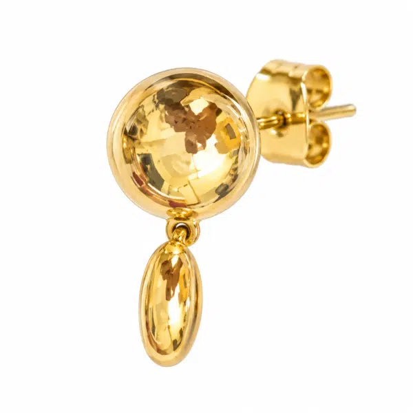 Close-up profile of gold stud drop earring