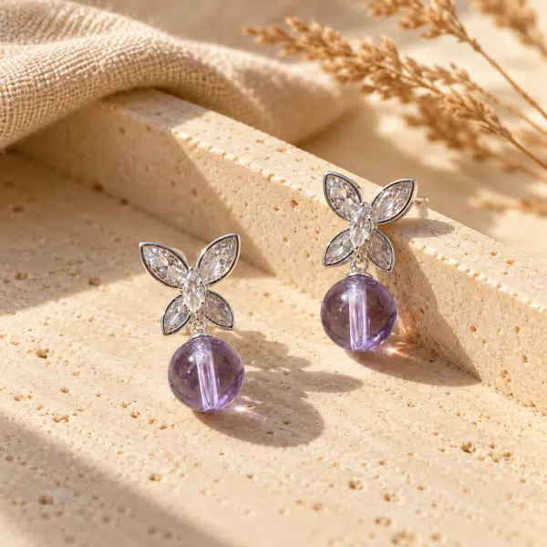 Papillon Crystal Drop Earrings styled on a display