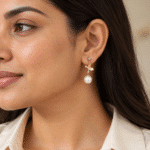 Papillon Pearl Gold Drop Earrings worn by a model