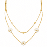 Layered gold necklace featuring white floral petals