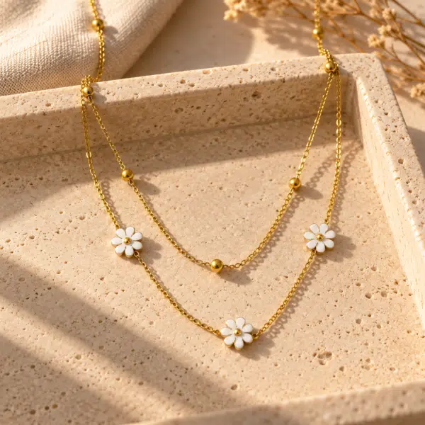 Layered gold necklace featuring white floral petals