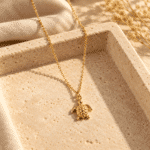 Serene Turtle Gold Necklace styled on a display