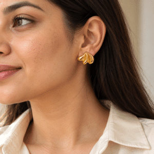 Woman wearing Shell-Kissed Gold Plated Studs on her ear