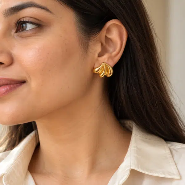Shell-Kissed Gold Studs worn by a model