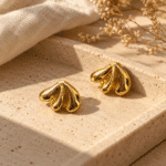 Shell-Kissed Gold Studs styled on a display