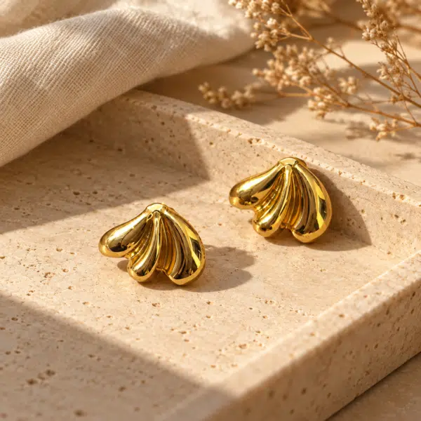 Shell-Kissed Gold Studs styled on a display