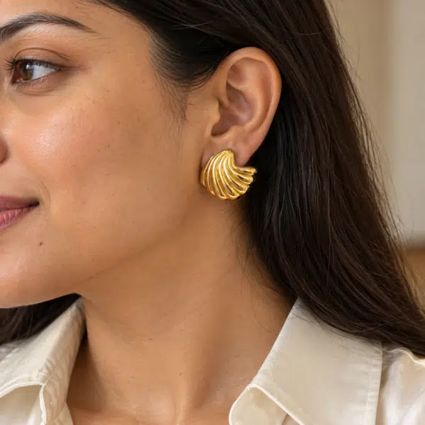 Wave Shell Gold Studs worn by a model