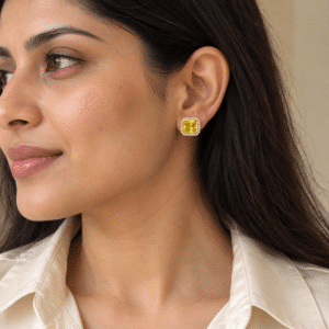 A woman wearing the Solara Yellow Stone Studs, highlighting their elegant size and warm glow against her skin
