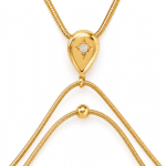 Close up view of the stellar teardrop pendant and delicate gold chains