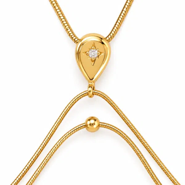 Close up view of the stellar teardrop pendant and delicate gold chains