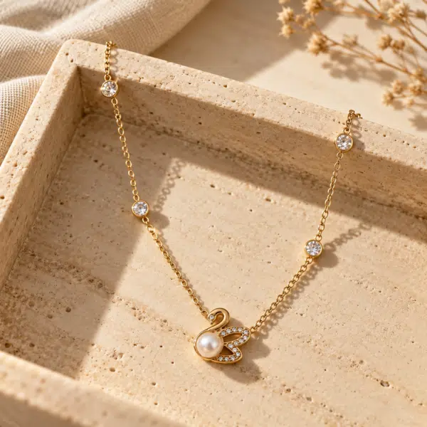 Swan Lake Gold Pearl Necklace styled on a display