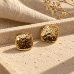 Textured Gold Stud Earrings styled on a display